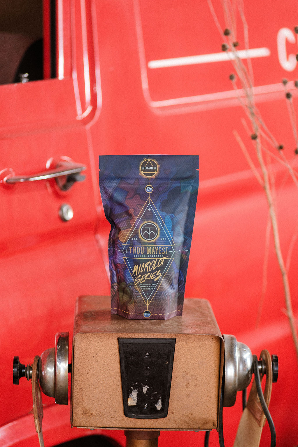 Microlot Series No. 4 coffee bag in front of a vintage vehicle
